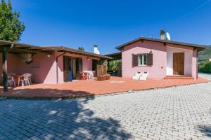 a house with a patio in front of it at Villa Roberta Marina di Campo in Marina di Campo