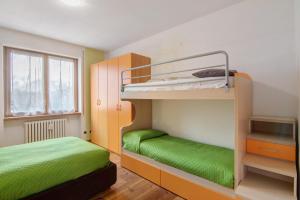 a bedroom with two bunk beds and a window at Como Lake Home in Colico