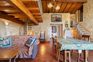 a living room with a couch and a table at Gite La Roseraie in Saint-Émilion