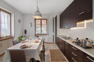 a kitchen with a table with a white table cloth at Como Lake Home in Colico