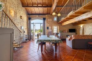 a living room with a table and a couch at Gite La Roseraie in Saint-Émilion