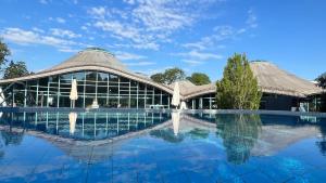 a building with a swimming pool in front of it at Ferienwohnung Sieglinde in Bad Dürrheim