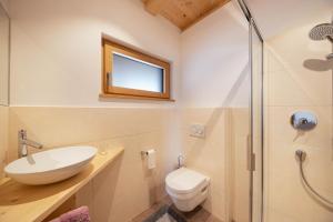 a bathroom with a toilet and a sink and a shower at Ferienwohnung 2 Weger in Andrian