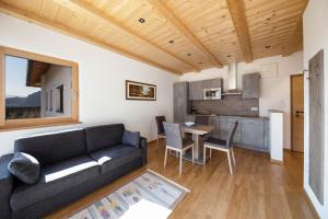 a living room with a couch and a table at Ferienwohnung 2 Weger in Andrian