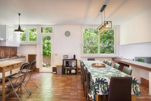 a dining room and kitchen with a table and chairs at Villa Brancolino - Fine Living in Garda