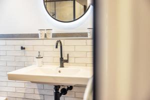 a bathroom with a sink and a mirror at Ferienwohnung Jost in Sundern +16 photos