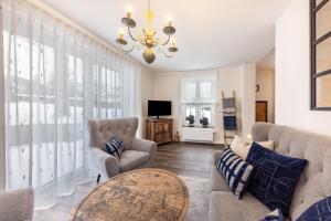 a living room with a couch and chairs and a table at Ferienwohnung Jost in Sundern