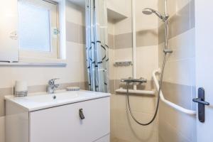 a bathroom with a shower and a sink at Maison traditionnelle au centre in Les Sables-d'Olonne +12 photos