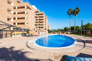 a large swimming pool in front of a building at Quintana's Home Oropesa Del Mar in El Borseral