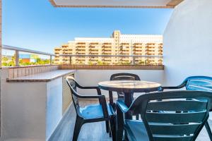 a table and chairs on a balcony with a building at Quintana's Home Oropesa Del Mar in El Borseral