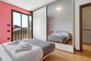 a bedroom with two beds and a large window at Katzemburg 5 Plus in Arco