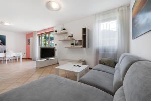 a living room with a couch and a table at Katzemburg 5 Plus in Arco