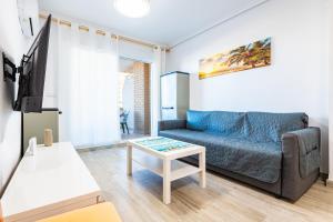 a living room with a couch and a table at Quintana's Home Oropesa Del Mar in El Borseral
