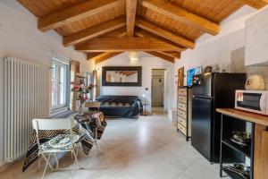 a kitchen and living room with a black refrigerator at Maison Nature e Relax Rubino in Osiglia