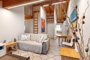 a living room with a couch and a table at Il Nido Aosta in Aosta