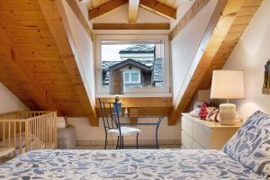 a bedroom with a bed and a window at Il Nido Aosta in Aosta