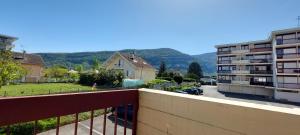 a balcony with a view of a building at Au calme avec balcon proche Genève in Gaillard
