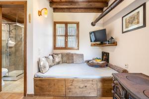 a bedroom with a bed and a tv and a tub at Traditional Thea Home Vati Rhodes in Vátion