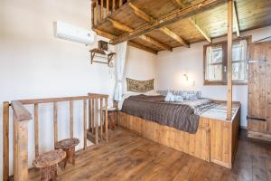 a bedroom with a bed in a room with wooden floors at Traditional Thea Home Vati Rhodes in Vátion