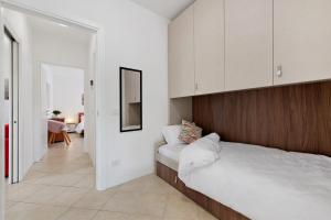 a bedroom with a large bed with a wooden headboard at Everlakegarda in Desenzano del Garda +58 photos