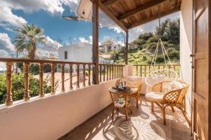 a balcony with chairs and a table with a view at Traditional Thea Home Vati Rhodes in Vátion