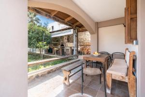 a dining room with a table and chairs and a window at Traditional Thea Home Vati Rhodes in Vátion