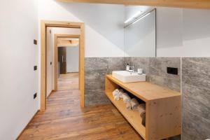 a bathroom with a sink and a mirror at Olympic Chalet 13 in Bormio +12 photos