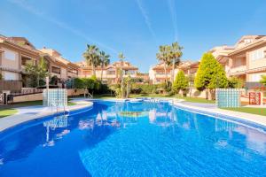 a large swimming pool in a yard with houses at Casa Mario in Puerto Marino