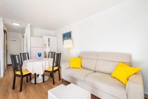 a living room with a couch and a table with yellow pillows at Mon Repaire à Frejus - proche plage in Fréjus