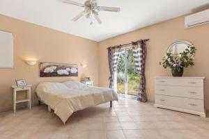 a bedroom with a bed and a dresser and a window at La Cabri 5 Chambres Piscine in Cabris +28 photos