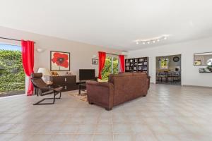 a living room with a couch and a chair at La Cabri 5 Chambres Piscine in Cabris