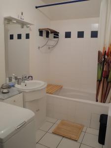 a white bathroom with a tub and a sink at Côte fleurie -Le Cottage D'honfleur in Honfleur +30 photos