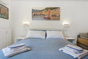 a bedroom with a bed with towels on it at Portofino Garden in Rapallo