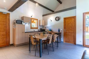 a kitchen with a table and chairs in a room at Chalet Arclosan - Val de Tamié in Faverges +15 photos