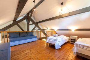 a attic room with two beds and a couch at Chalet Arclosan - Val de Tamié in Faverges