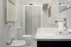 a white bathroom with a toilet and a sink at Portofino Garden in Rapallo +28 photos