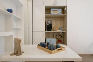 a white kitchen with a table with a box on it at Portofino Garden in Rapallo