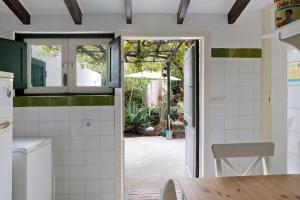 a kitchen with a door leading to a patio at Casa Julia in Las Lagunas