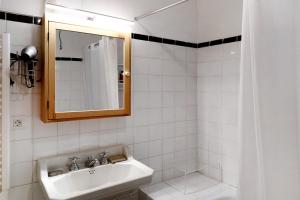 a white bathroom with a sink and a mirror at Casa Julia in Las Lagunas +20 photos