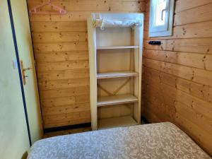 a room with a bed and a book shelf at Maison De Plage La Grise Brèche in Pirou