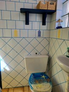 a bathroom with a toilet and a sink at Maison De Plage La Grise Brèche in Pirou