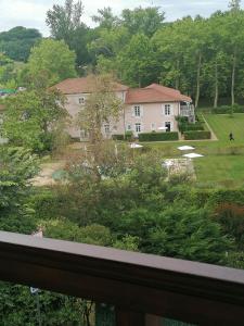 a view of a house from a balcony at Les Alisiers in Eugénie-les-Bains