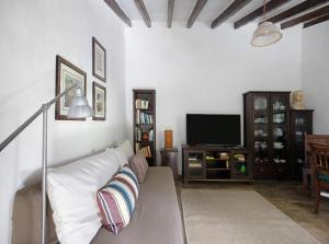 a living room with a couch and a tv at Casa Julia in Las Lagunas