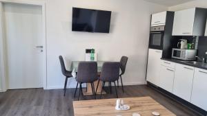 a kitchen with a table and chairs in a room at Ferienhaus zum Wunschglockerl in Schrems