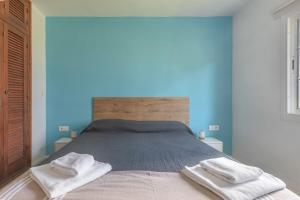 a bedroom with a bed with two towels on it at Giuliana Apartment in Alaior +24 photos