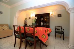 a dining room table and chairs with a red table cloth at Romantic Villa with private Pool in Adeje