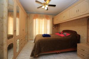 a bedroom with a bed and a ceiling fan at Romantic Villa with private Pool in Adeje +22 photos