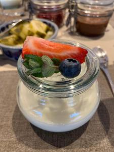 a glass jar with a piece of fruit and a blueberry at Eichernhof Apartment Kirschblüte in Verano +21 photos
