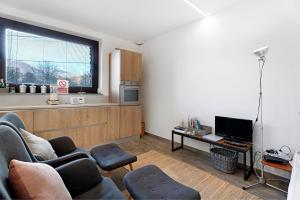 a living room with a couch and a tv at Charmingly Renovated Stone House in Cesara