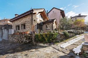 a stone house with a stone wall at Charmingly Renovated Stone House in Cesara